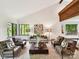 Spacious living room featuring vaulted ceilings, wood beams, neutral décor, and abundant natural light at 6017 Lake Providence Ln, Charlotte, NC 28277