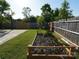 Well-maintained backyard with a raised garden bed, ideal for gardening enthusiasts and outdoor enjoyment at 6114 Paw Village Rd, Charlotte, NC 28214