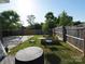 Spacious backyard with a basketball court, outdoor seating, and lush greenery, creating a relaxing outdoor space at 6114 Paw Village Rd, Charlotte, NC 28214