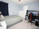 Cozy bedroom with a comfortable bed, desk and gaming setup, and plenty of space to relax and focus at 6114 Paw Village Rd, Charlotte, NC 28214