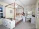 Serene bedroom featuring a four-poster bed, vanity area, and stylish decor that create a relaxing space at 6114 Paw Village Rd, Charlotte, NC 28214