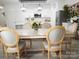 Bright dining room featuring a wooden table, chairs, and a view into the modern, well-equipped kitchen at 6114 Paw Village Rd, Charlotte, NC 28214
