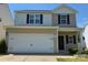 Two-story home with a neutral color scheme and a large two-car garage at 6114 Paw Village Rd, Charlotte, NC 28214