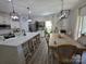 Spacious kitchen with large island, seating, and adjacent dining area at 6114 Paw Village Rd, Charlotte, NC 28214