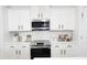 Modern kitchen with white cabinets, stainless steel appliances, and tiled backsplash at 6114 Paw Village Rd, Charlotte, NC 28214