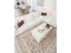 Open living room design with white sofa, area rug and decorative pillows at 6114 Paw Village Rd, Charlotte, NC 28214