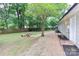 Fenced-in backyard featuring stone benches and mature trees at 6409 Pineburr Ct, Charlotte, NC 28211
