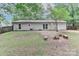 Back of home view featuring an outdoor seating area with mature trees and an expansive grassy lawn at 6409 Pineburr Ct, Charlotte, NC 28211