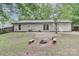 Home backyard showing outdoor seating, green grass, and ample space for outdoor activities at 6409 Pineburr Ct, Charlotte, NC 28211