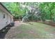 Spacious backyard with a fire pit and mature trees, perfect for outdoor entertaining and relaxation at 6409 Pineburr Ct, Charlotte, NC 28211