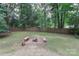 Open backyard with a fire pit and perimeter fence, creating a private outdoor space at 6409 Pineburr Ct, Charlotte, NC 28211