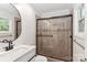 Modern bathroom with a glass-enclosed shower, sleek vanity, and stylish fixtures at 6409 Pineburr Ct, Charlotte, NC 28211