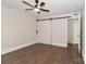 Neutral bedroom with ceiling fan, wood-look flooring, and a stylish barn door, providing a modern touch at 6409 Pineburr Ct, Charlotte, NC 28211