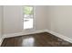 A comfortable bedroom with hardwood floors and a view to the outside at 6409 Pineburr Ct, Charlotte, NC 28211