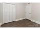 This bedroom features wood-look floors and a closet for storage at 6409 Pineburr Ct, Charlotte, NC 28211