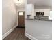 Inviting entryway features hardwood floors, modern lighting and flows into a charming kitchen with stainless steel appliances at 6409 Pineburr Ct, Charlotte, NC 28211