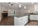 Open-concept kitchen with granite countertops, stainless appliances, and seamless flow to living area with fireplace at 6409 Pineburr Ct, Charlotte, NC 28211
