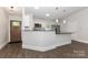 Bright kitchen with white cabinets and stainless steel appliances offers an open design at 6409 Pineburr Ct, Charlotte, NC 28211