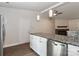 Modern kitchen with granite countertops and stainless steel appliances, leading to a bright living space at 6409 Pineburr Ct, Charlotte, NC 28211