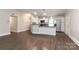 Charming kitchen with white cabinetry and stainless steel appliances is seamlessly connected to the living space at 6409 Pineburr Ct, Charlotte, NC 28211