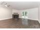 Bright living room with a ceiling fan and a stone fireplace with wooden mantel and access to outdoors at 6409 Pineburr Ct, Charlotte, NC 28211