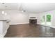 Spacious living room with fireplace and access to the outdoors through glass paneled doors at 6409 Pineburr Ct, Charlotte, NC 28211