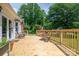 Wooden deck with seating area overlooking the backyard with mature trees and lush greenery at 712 2Nd Nw Ave, Conover, NC 28613