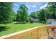 Spacious and scenic backyard with mature trees as viewed from the wooden deck at 712 2Nd Nw Ave, Conover, NC 28613