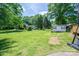 Spacious backyard with mature trees and a storage shed, perfect for outdoor living at 712 2Nd Nw Ave, Conover, NC 28613
