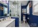 Bathroom featuring blue walls, marble tile, a glass shower and brushed nickel fixtures at 712 2Nd Nw Ave, Conover, NC 28613