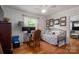 Bedroom with hardwood floors, a daybed, a ceiling fan, and a workspace at 712 2Nd Nw Ave, Conover, NC 28613