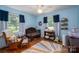 Bedroom featuring a crib, rocking chair, window, and an area rug at 712 2Nd Nw Ave, Conover, NC 28613