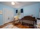 Bedroom featuring a crib, rocking chair, window, and closet at 712 2Nd Nw Ave, Conover, NC 28613