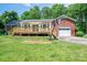 View of the house with deck, backyard, basketball hoop, and garage at 712 2Nd Nw Ave, Conover, NC 28613