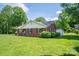 Brick home with manicured lawn, decorative shrubbery and an outbuilding at 712 2Nd Nw Ave, Conover, NC 28613