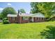 Lovely brick home on a lush lawn, featuring dark shutters and mature trees at 712 2Nd Nw Ave, Conover, NC 28613