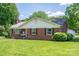 Charming brick home featuring black shutters, a well-manicured lawn, and inviting front porch at 712 2Nd Nw Ave, Conover, NC 28613
