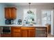 Galley kitchen featuring stainless steel appliances, wood cabinets, and a sink under a window at 712 2Nd Nw Ave, Conover, NC 28613