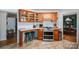 A kitchen featuring wood cabinets, bar seating, stainless steel appliances, and tile floors at 712 2Nd Nw Ave, Conover, NC 28613