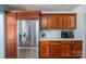 Kitchen with stainless steel refrigerator, white subway tile backsplash, and wood cabinetry at 712 2Nd Nw Ave, Conover, NC 28613