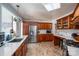 This kitchen boasts stainless appliances, a window, wood cabinets, and tile floors at 712 2Nd Nw Ave, Conover, NC 28613