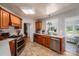 Galley kitchen with stainless appliances, wood cabinets, and a kitchen island with bar stools at 712 2Nd Nw Ave, Conover, NC 28613