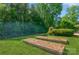 A well-maintained backyard features garden beds and an inviting outdoor space perfect for gardening and relaxation at 7128 Rock Bass Ct, Concord, NC 28025