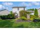 A landscaped backyard features a manicured lawn and lush greenery, creating a serene outdoor oasis for relaxation and entertainment at 7128 Rock Bass Ct, Concord, NC 28025