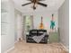 Comfortable bedroom featuring a leather loveseat, carpeted floors, neutral walls and guitars at 7128 Rock Bass Ct, Concord, NC 28025