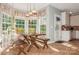 Bright dining area featuring a wooden table set by a bay window, tiled floors and white accents at 7128 Rock Bass Ct, Concord, NC 28025