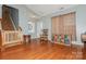 Open living room featuring hardwood floors, a staircase, and a cozy seating area at 7128 Rock Bass Ct, Concord, NC 28025