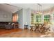 Open concept living room with tile and wood flooring, blue walls, bay windows and comfortable seating at 7128 Rock Bass Ct, Concord, NC 28025