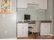 Functional home office nook featuring built-in cabinets, a desk, and a comfortable chair at 7128 Rock Bass Ct, Concord, NC 28025