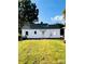 Back side of home with a lush yard, and traditional design elements and siding at 716 E Union St, Marshville, NC 28103